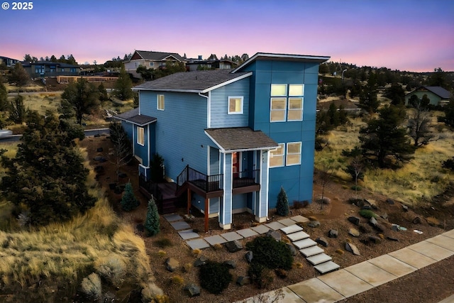 view of back house at dusk