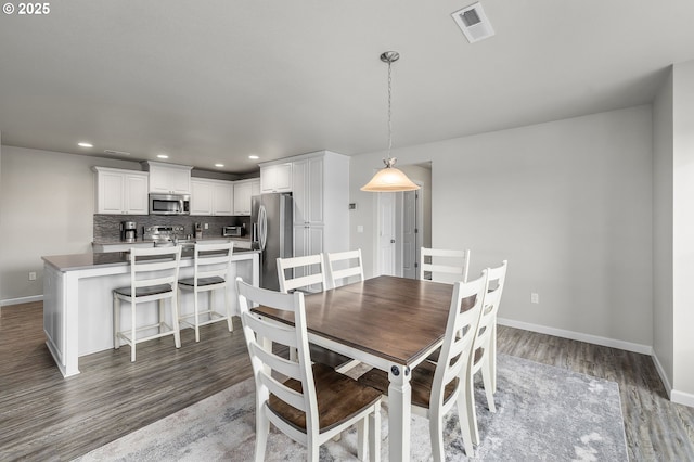 dining room with dark wood-type flooring