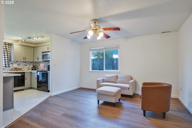 1819 SE 173rd Ave, Vancouver, WA 98683 - living area featuring light wood finished floors, ceiling fan, and baseboards