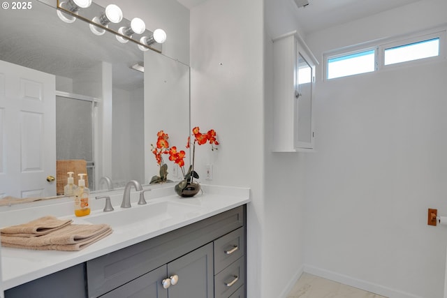 1819 SE 173rd Ave, Vancouver, WA 98683 - bathroom featuring vanity, baseboards, an enclosed shower, and marble look tile flooring