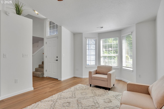 1819 SE 173rd Ave, Vancouver, WA 98683 - sitting room with stairs, light wood-type flooring, baseboards, and a textured ceiling