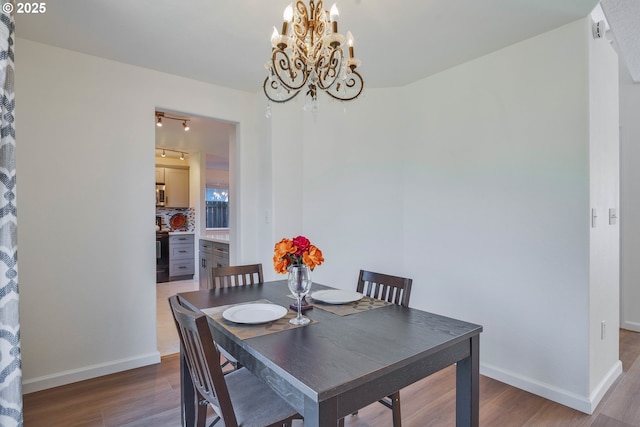 1819 SE 173rd Ave, Vancouver, WA 98683 - dining room with wood finished floors, a chandelier, baseboards, and rail lighting
