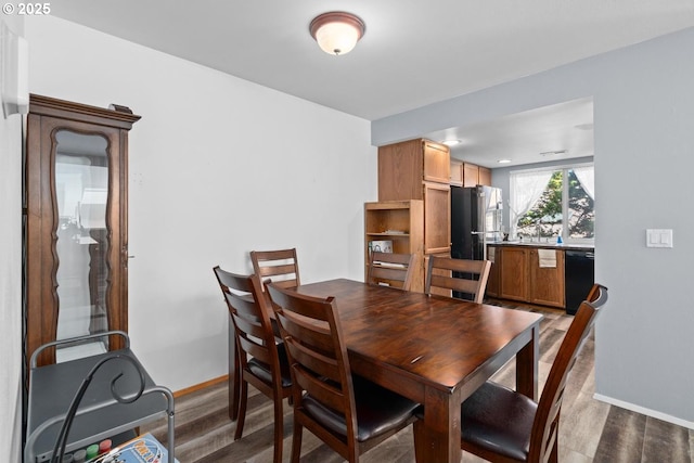dining room with wood finished floors and baseboards