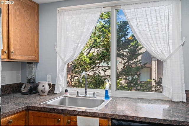 kitchen featuring a sink and brown cabinetry