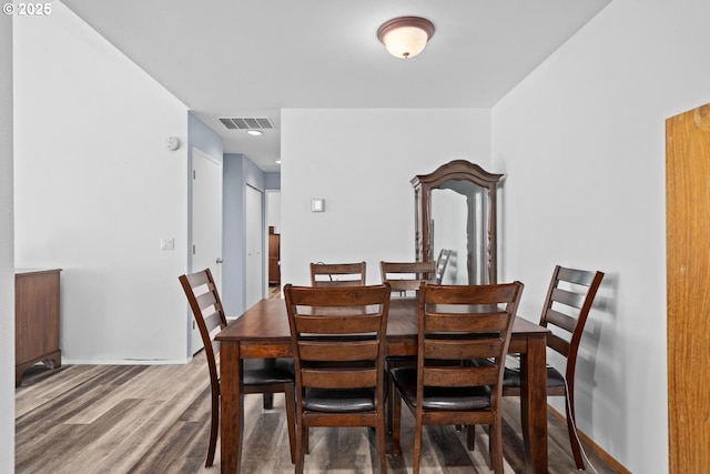 dining area with wood finished floors and baseboards