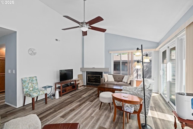 living room featuring high vaulted ceiling, wood finished floors, ceiling fan, and a fireplace