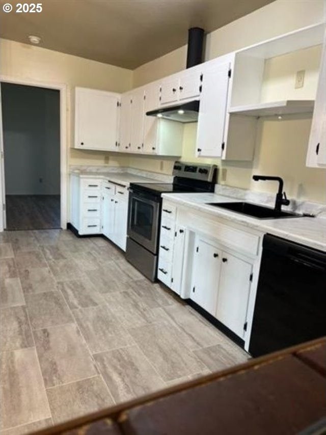 1127 6th Ave, Albany, OR 97321 - kitchen with black dishwasher, stainless steel electric range oven, under cabinet range hood, and light countertops