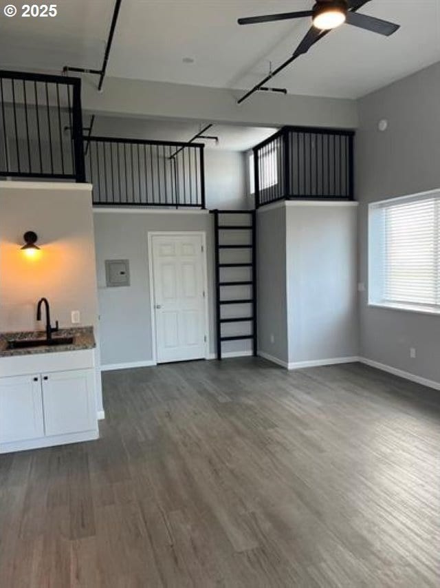 1127 6th Ave, Albany, OR 97321 - unfurnished living room featuring ceiling fan, dark wood finished floors, and a towering ceiling