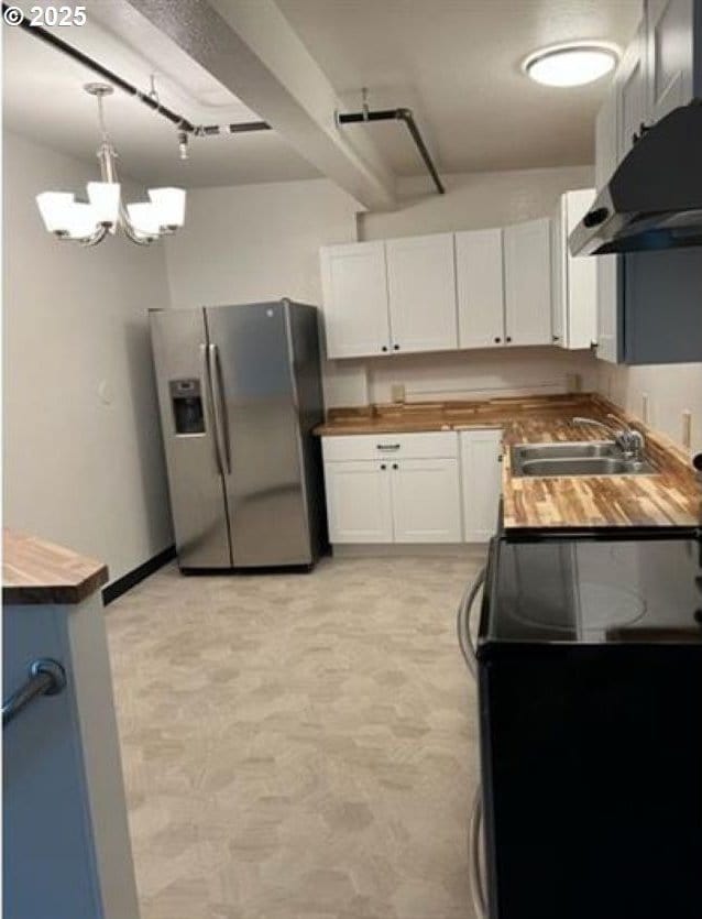 1127 6th Ave, Albany, OR 97321 - kitchen featuring stainless steel fridge, under cabinet range hood, wood counters, electric range oven, and white cabinets