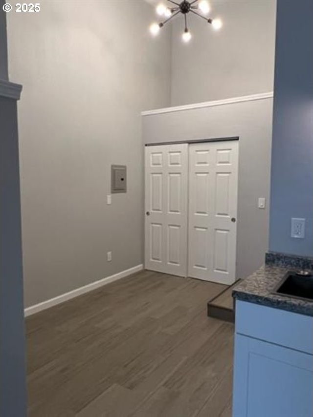 1127 6th Ave, Albany, OR 97321 - kitchen with dark wood-style floors, a high ceiling, and a chandelier