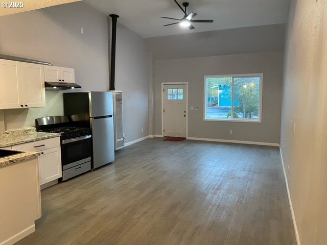 1127 6th Ave, Albany, OR 97321 - kitchen featuring appliances with stainless steel finishes, lofted ceiling, under cabinet range hood, wood finished floors, and white cabinets