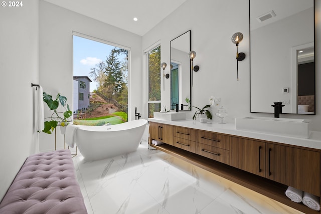 750 NE Province Ct, Camas, WA 98607 - bathroom with marble tiled flooring, double vanity, a freestanding tub, and recessed lighting