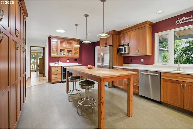 19985 SW Carlin Blvd, Beaverton, OR 97078 - kitchen featuring stainless steel appliances, wine cooler, glass insert cabinets, brown cabinetry, and butcher block counters