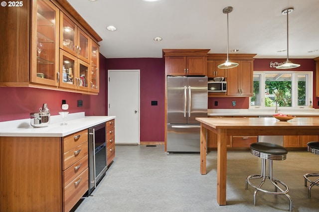 19985 SW Carlin Blvd, Beaverton, OR 97078 - kitchen with stainless steel appliances, beverage cooler, pendant lighting, and brown cabinetry