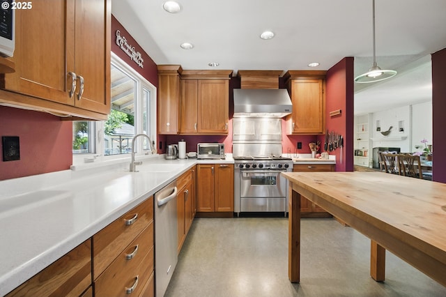 19985 SW Carlin Blvd, Beaverton, OR 97078 - kitchen with stainless steel appliances, wall chimney range hood, butcher block countertops, hanging light fixtures, and brown cabinets