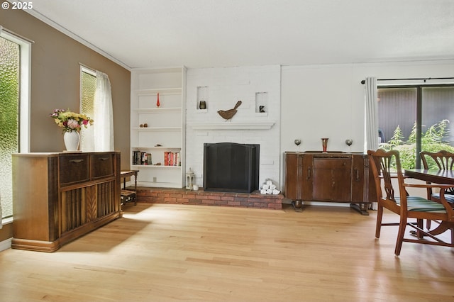 19985 SW Carlin Blvd, Beaverton, OR 97078 - living area featuring wood finished floors, built in shelves, a brick fireplace, and ornamental molding