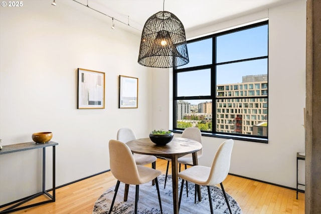 333 NW 9th Ave Unit 1323, Portland, OR 97209 - dining room featuring a chandelier, rail lighting, and hardwood / wood-style flooring