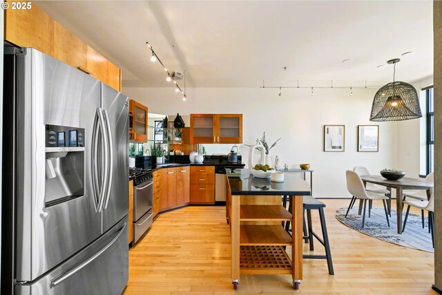 333 NW 9th Ave Unit 1323, Portland, OR 97209 - full bath featuring vanity, toilet, a wainscoted wall, tile patterned floors, and tile walls