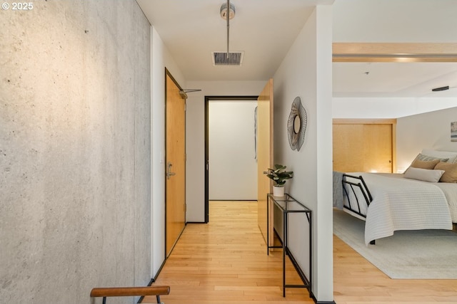 hallway with light hardwood / wood-style floors