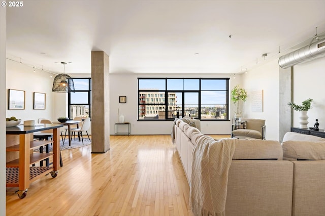 333 NW 9th Ave Unit 1323, Portland, OR 97209 - living area with rail lighting, light wood-style floors, and healthy amount of natural light