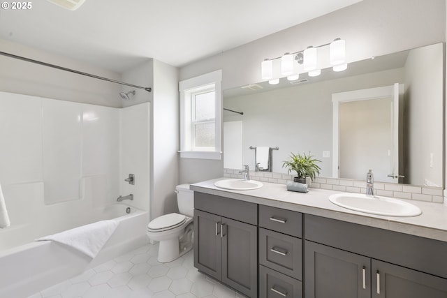 21338 SW Simon Ter, Sherwood, OR 97140 - bathroom featuring double vanity, shower / bathtub combination, tile patterned floors, and backsplash