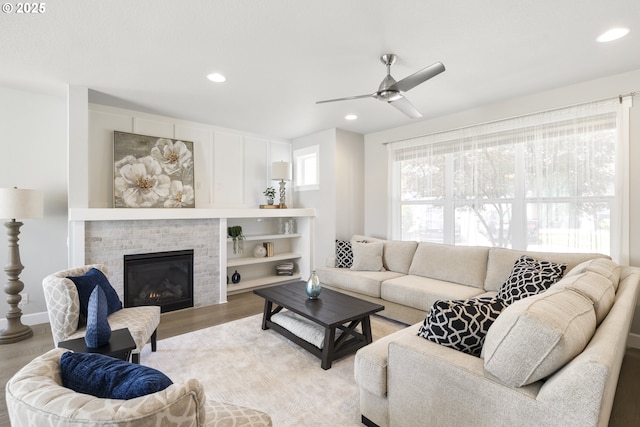 21338 SW Simon Ter, Sherwood, OR 97140 - living room featuring a fireplace, light wood-type flooring, ceiling fan, and recessed lighting