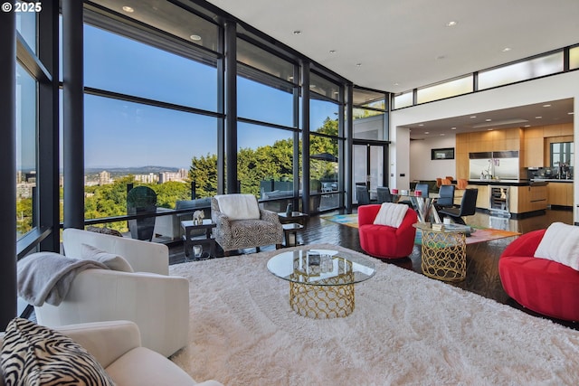 1551 SW Upper Hall St, Portland, OR 97201 - living room with expansive windows, wood finished floors, recessed lighting, wine cooler, and a high ceiling