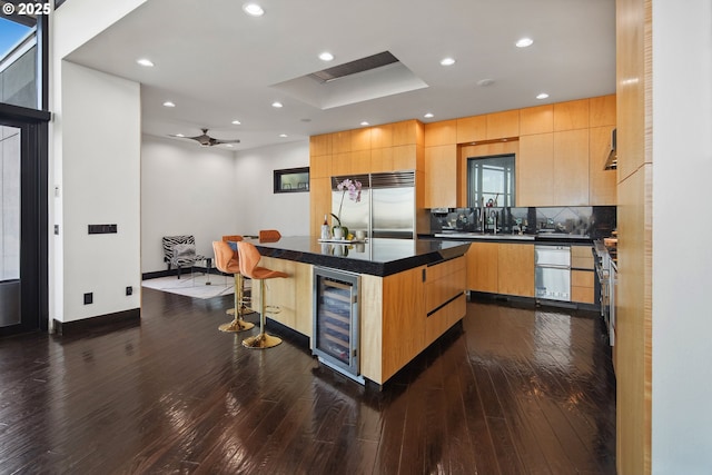 1551 SW Upper Hall St, Portland, OR 97201 - kitchen with stainless steel built in refrigerator, wine cooler, a kitchen breakfast bar, a kitchen island, and modern cabinets