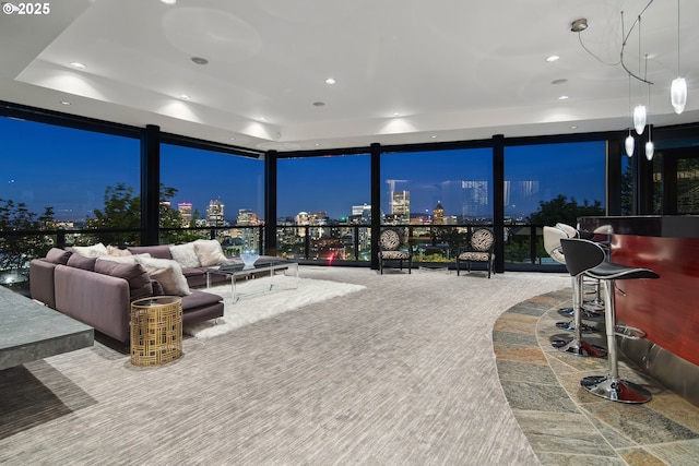 1551 SW Upper Hall St, Portland, OR 97201 - living room featuring a wall of windows, a raised ceiling, recessed lighting, a view of city lights, and carpet floors