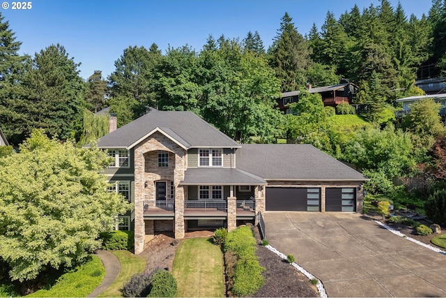7820 SE 114th Ave, Portland, OR 97266 - view of front of home with a chimney, a garage, concrete driveway, stone siding, and a porch