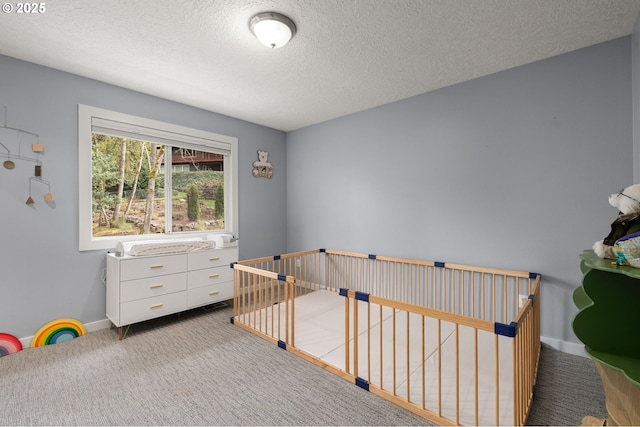 7820 SE 114th Ave, Portland, OR 97266 - bedroom featuring carpet floors, a textured ceiling, a crib, and baseboards