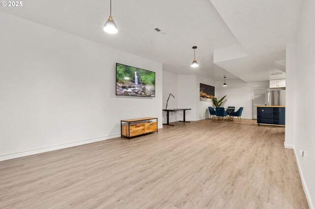 7820 SE 114th Ave, Portland, OR 97266 - unfurnished living room featuring light wood-type flooring and baseboards