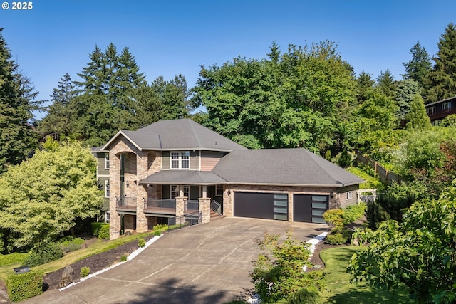 7820 SE 114th Ave, Portland, OR 97266 - view of front of property featuring stone siding, a garage, concrete driveway, and covered porch