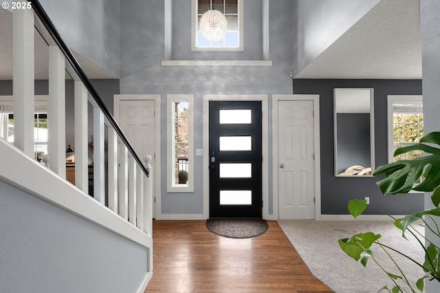 7820 SE 114th Ave, Portland, OR 97266 - entryway with a towering ceiling, wood finished floors, baseboards, and stairway