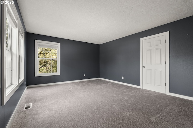 7820 SE 114th Ave, Portland, OR 97266 - carpeted empty room with a textured ceiling and baseboards