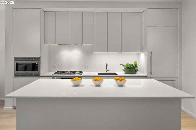 kitchen with light countertops, modern cabinets, appliances with stainless steel finishes, and a sink