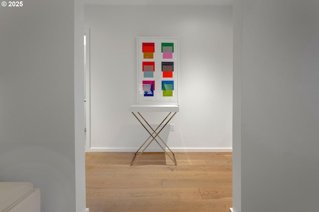 hallway with wood finished floors and baseboards