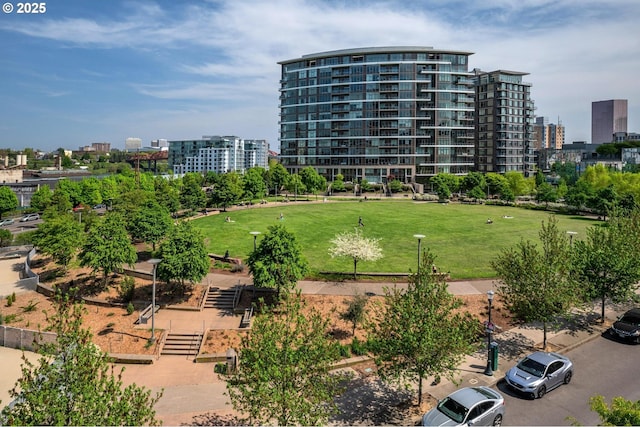 view of property's community with a city view and a lawn