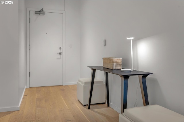 entryway with baseboards and light wood-style floors