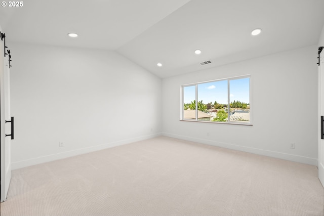 619 E Heintz St, Molalla, OR 97038 - spare room with a barn door, light carpet, recessed lighting, and lofted ceiling