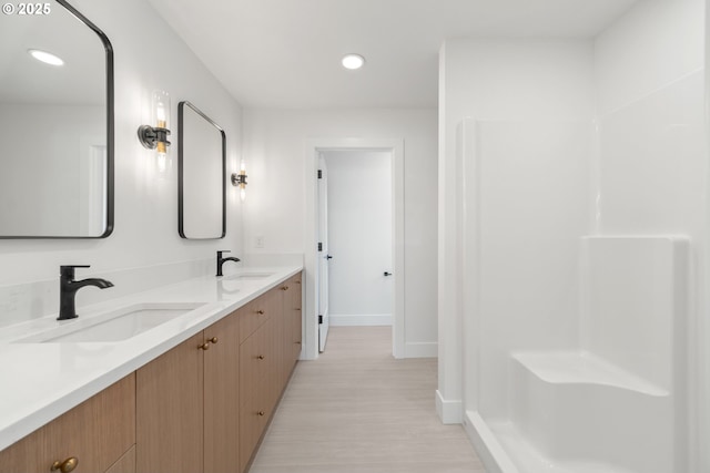 619 E Heintz St, Molalla, OR 97038 - full bathroom featuring wood finished floors, double vanity, and recessed lighting