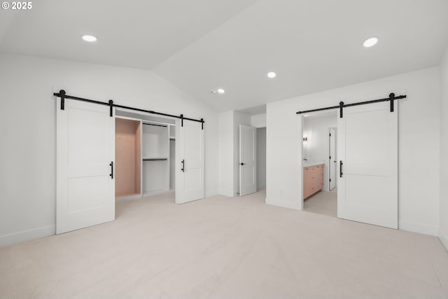 619 E Heintz St, Molalla, OR 97038 - unfurnished bedroom with a barn door, vaulted ceiling, light colored carpet, recessed lighting, and ensuite bath