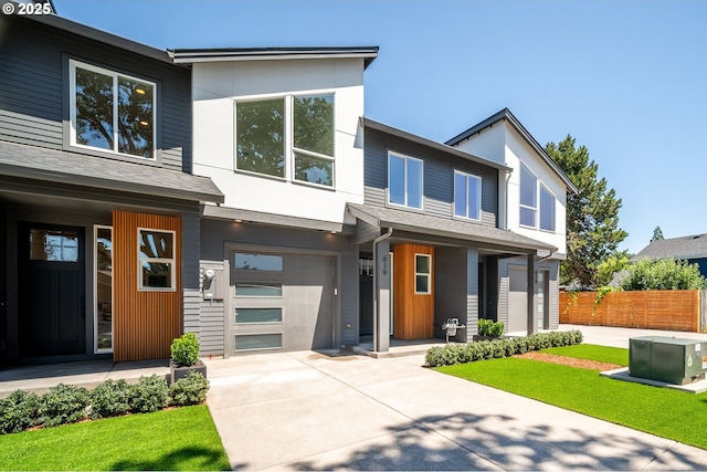 619 E Heintz St, Molalla, OR 97038 - modern home featuring covered porch, an attached garage, and concrete driveway