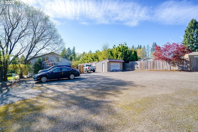 view of front of home featuring fence and an outdoor structure