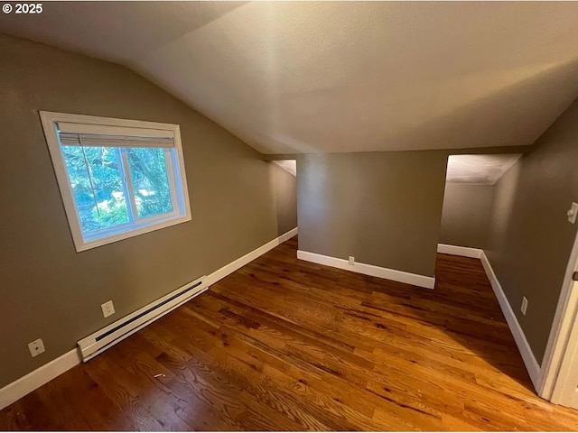 bonus room featuring a baseboard heating unit, lofted ceiling, wood finished floors, and baseboards