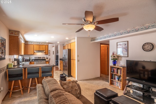 living area featuring light carpet, recessed lighting, and ceiling fan