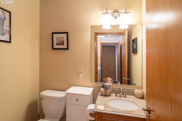 bathroom with toilet and vanity