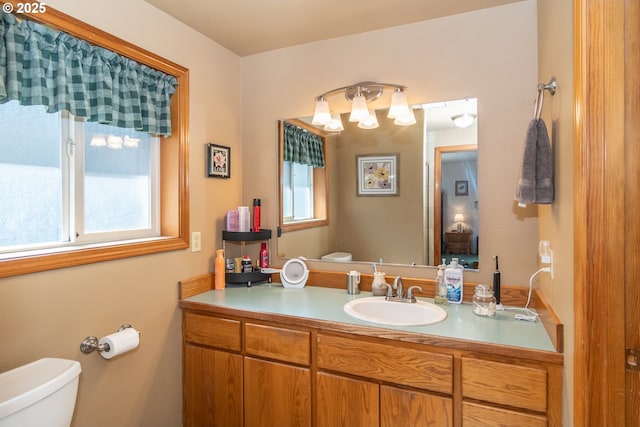 bathroom featuring toilet and vanity