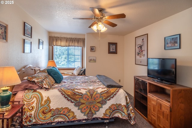 bedroom featuring a ceiling fan, a textured ceiling, carpet flooring, and a textured wall