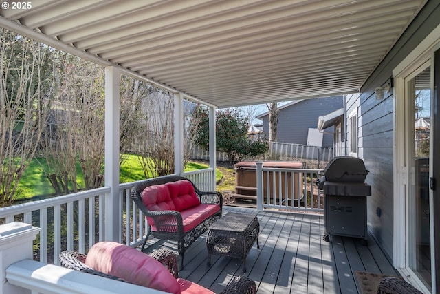 wooden terrace with outdoor lounge area, fence, and a grill